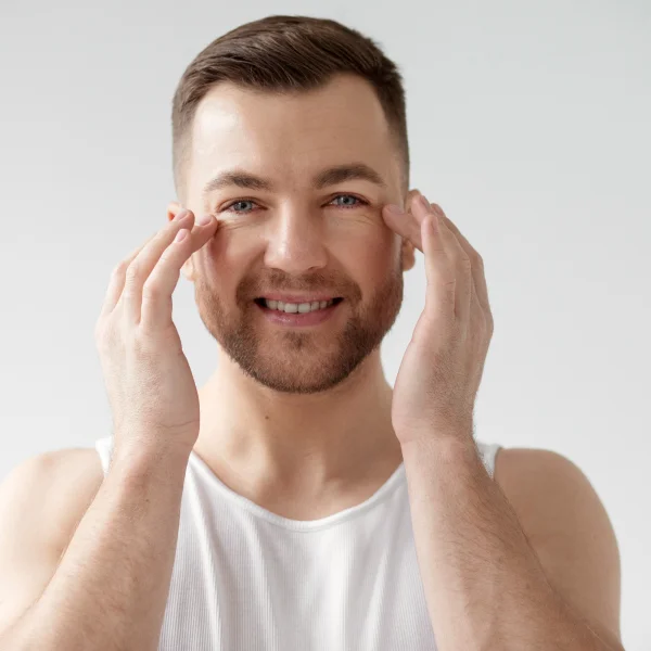 A man holds his hands to his face, representing the best treatment for facial rejuvenation.