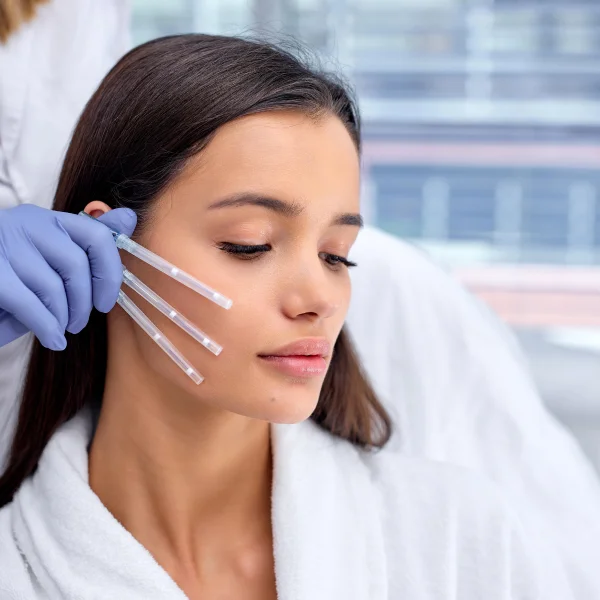 A woman receiving a facial injection for skin firming treatment.